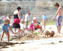 Playing on the beach at Newquay harbour